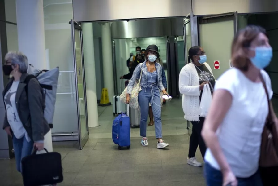 Travellers wearing face masks arrive from Paris to St Pancras Station (Victoria Jones/PA)