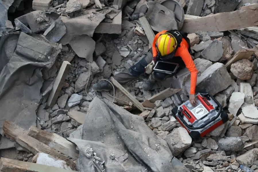 A Chilean rescuer uses a sound tracking machine. Photo: Hussein Malla/AP