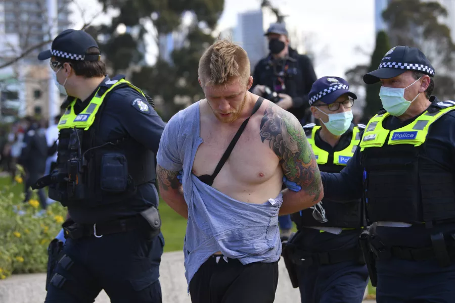 Police arrest a man as people gather at the so-called ‘Freedom Day’ protest in Melbourne (James Ross/AAP/AP)