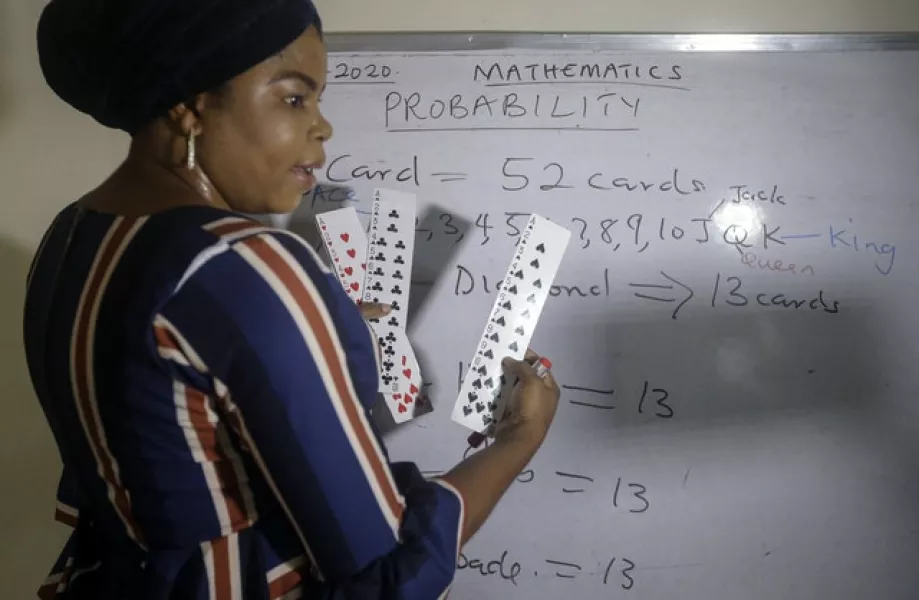 Ms Ajayi teaches probability theory with the aid of playing cards (Sunday Alamba/AP)