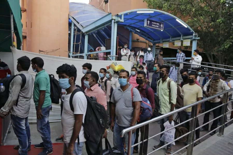 People queue for Covid-19 tests at a railway station in Ahmedabad, India (Ajit Solanki/AP)