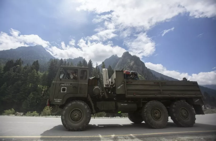 An Indian army convoy travels on the Srinagar- Ladakh highway (Mukhtar Khan/AP)