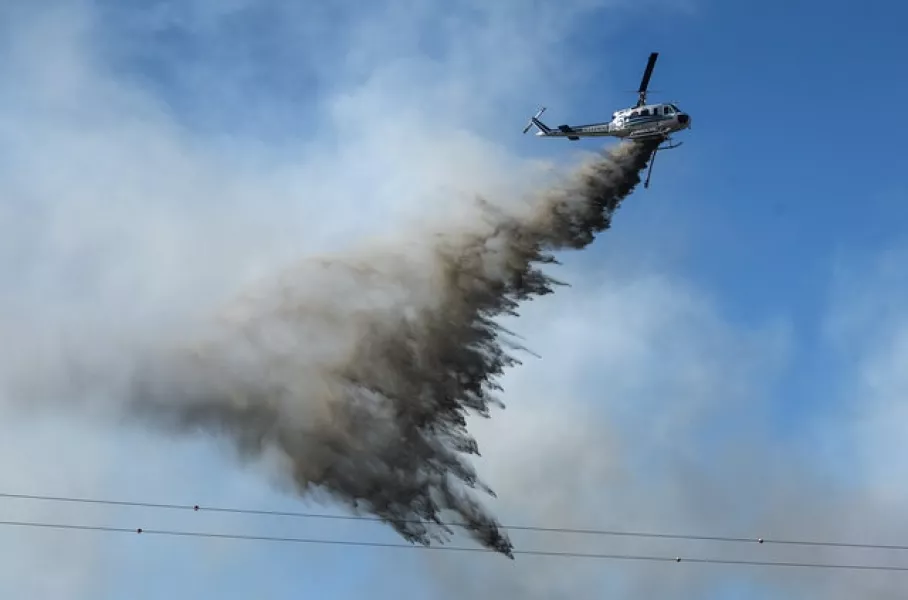 A helicopter responds to a brush fire in Vancouver, Washington (Alisha Jucevic/The Columbian via AP)
