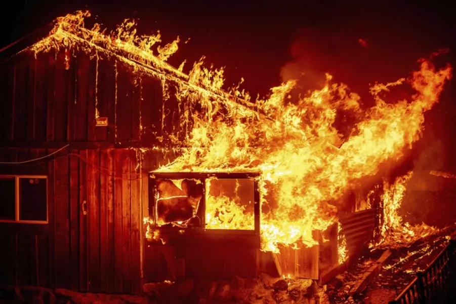 Flames shoot from a home as the Bear Fire burns through the Berry Creek area of Butte County, California (Noah Berger/AP)