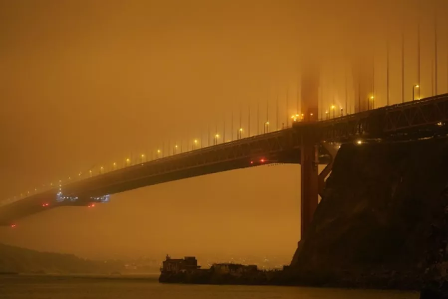 San Francisco’s Golden Gate Bridge is barely visible through smoke from nearby fires (Eric Risberg/AP)