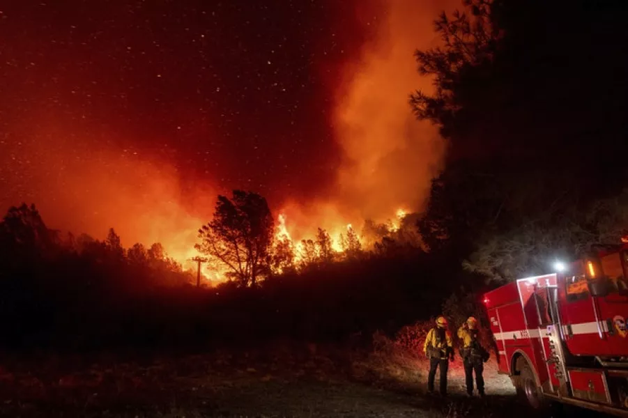 Firefighters watch a fire approach in Oroville, Calif, California (Noah Berger/AP)