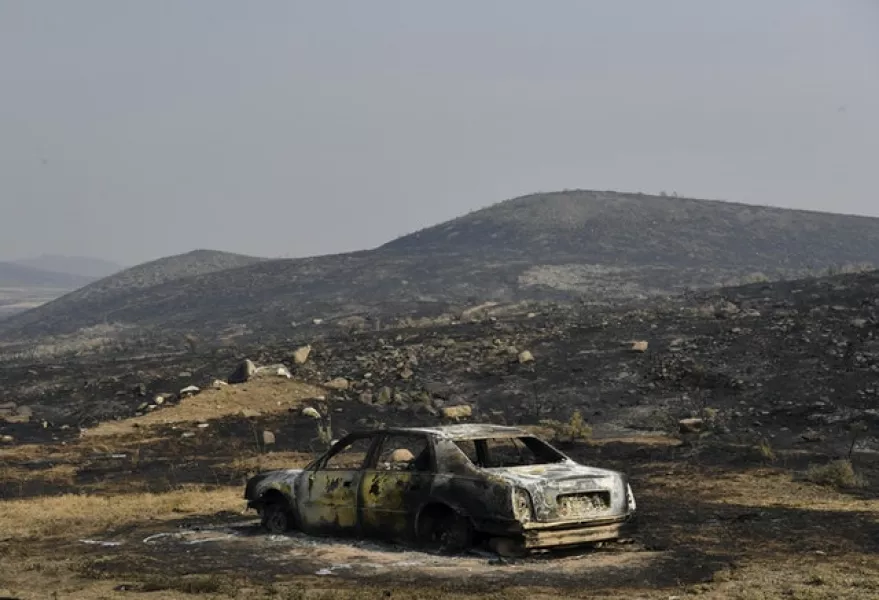 A car sits burnt out after a blaze near Brewster, Washington (Tyler Tjomsland/The Spokesman-Review/AP)