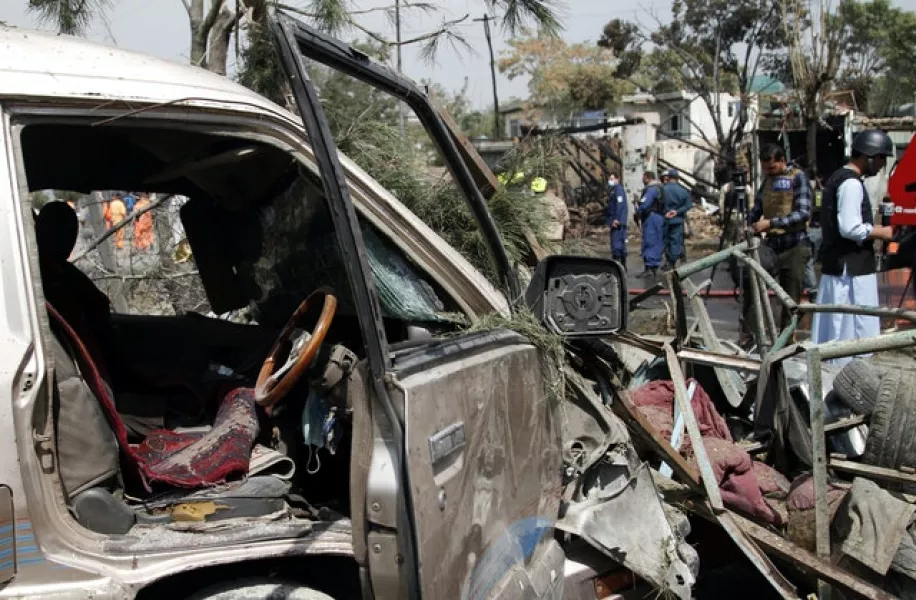 Afghan security personnel work at the site of an explosion in Kabul (AP)