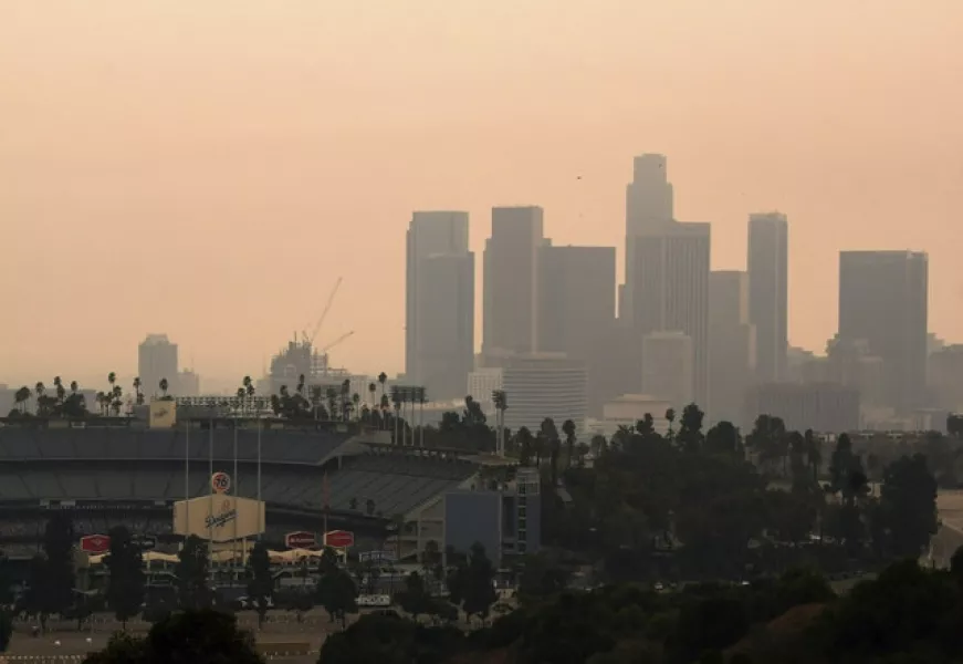 Downtown Los Angeles and Dodger Stadium are shrouded in smoke (The Orange County Register/AP)