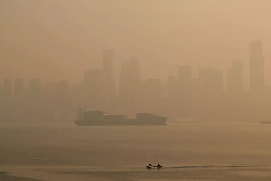Boaters pass by the Seattle skyline during hazy air conditions (The Seattle Times/AP)