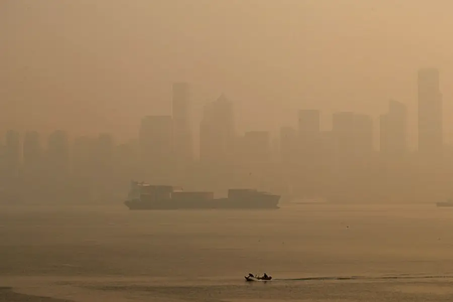 Boaters pass by the Seattle skyline during hazy air conditions (The Seattle Times/AP)