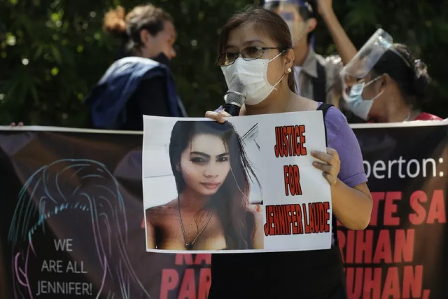 A protester holds a slogan with a photo of the killed transgender Filipino woman Jennifer Laude during a rally in Quezon city (Aaron Favila/AP)
