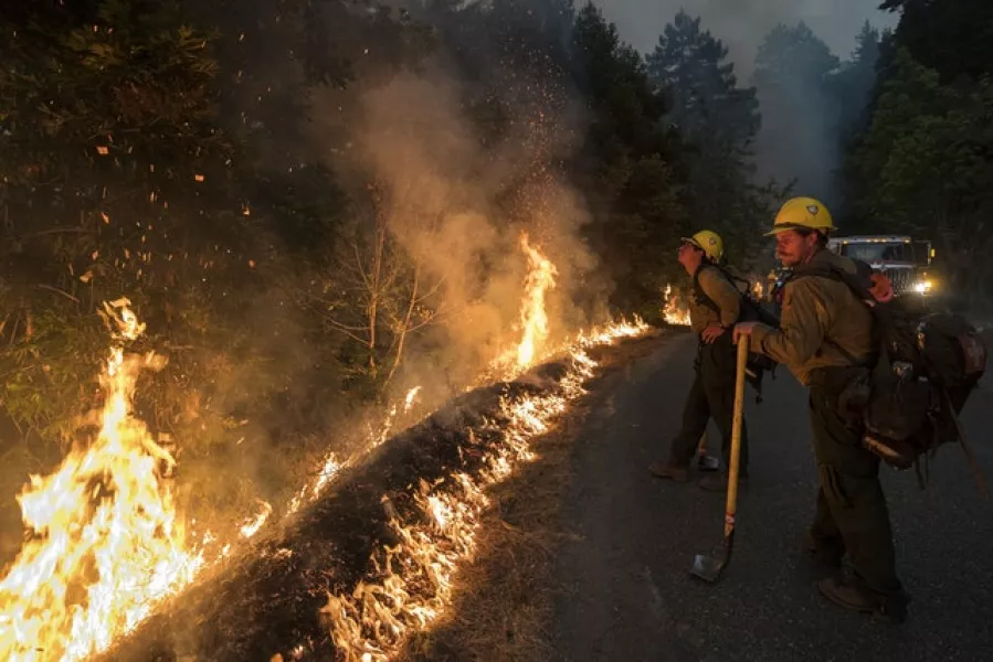 Firefighters monitor a controlled burn in California (Nic Coury/AP)