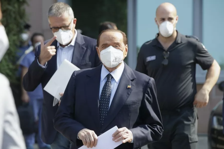 Silvio Berlusconi is flanked by his doctor Alberto Zangrillo (left) as he leaves the San Raffaele hospital in Milan (Luca Bruno/AP)