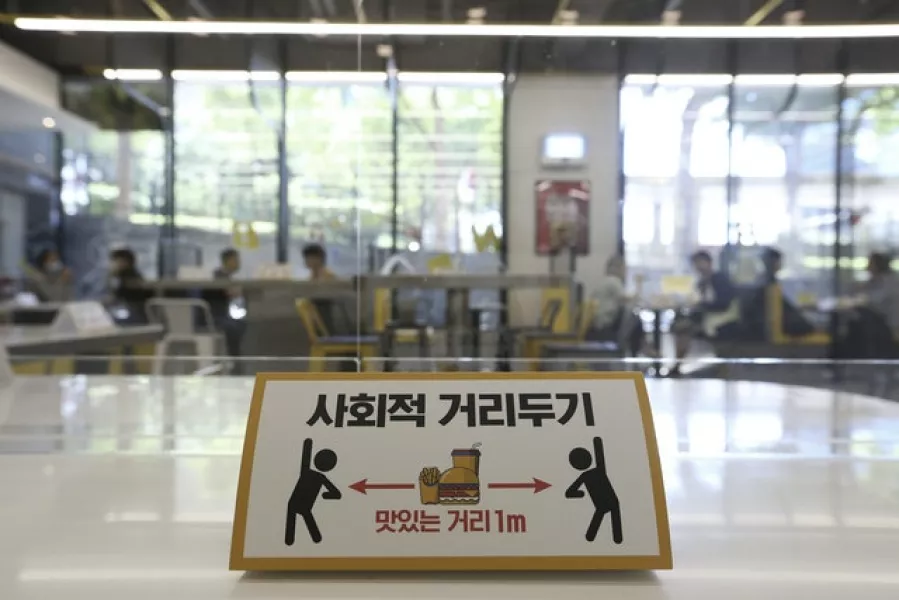 A social distancing sign at No Brand Burger in Seoul (AP)