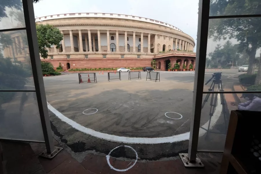 Markings to maintain physical distancing are seen on the ground outside the Parliament building in New Delhi (AP)