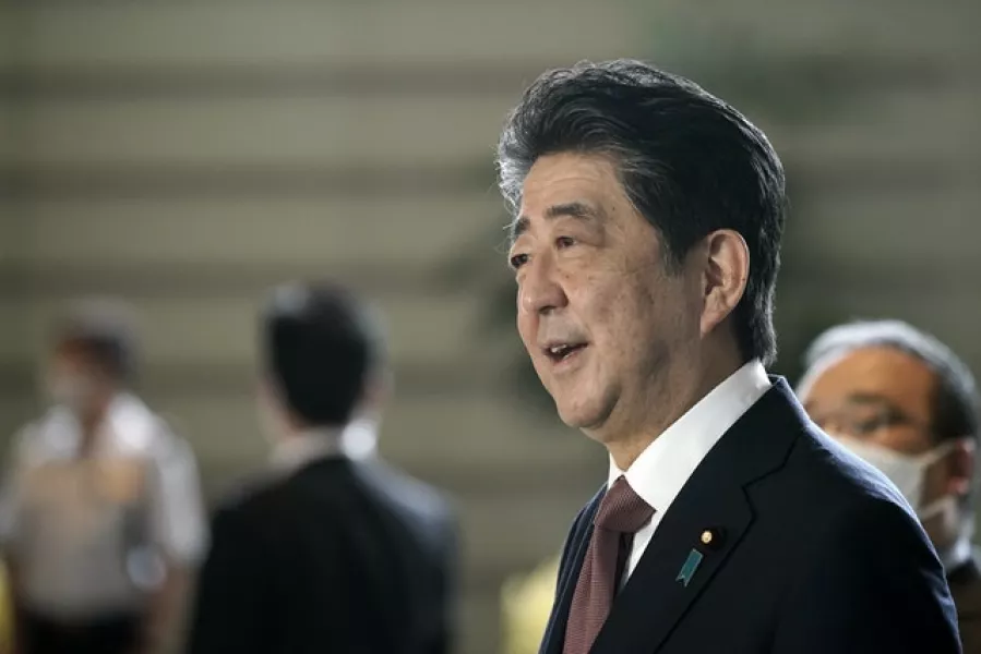 Shinzo Abe speaks to the media as he arrives for Wednesday’s cabinet meeting (Eugene Hoshiko/AP)
