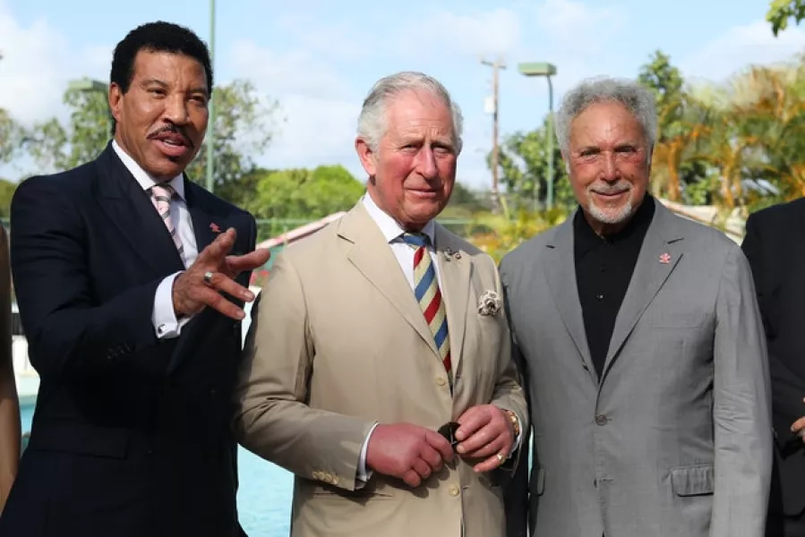 Members of the royal family, including the Prince of Wales who is shown meeting singer Lionel Richie and Sir Tom Jones, have enjoyed visits to Barbados over the years (Jane Barlow/PA)