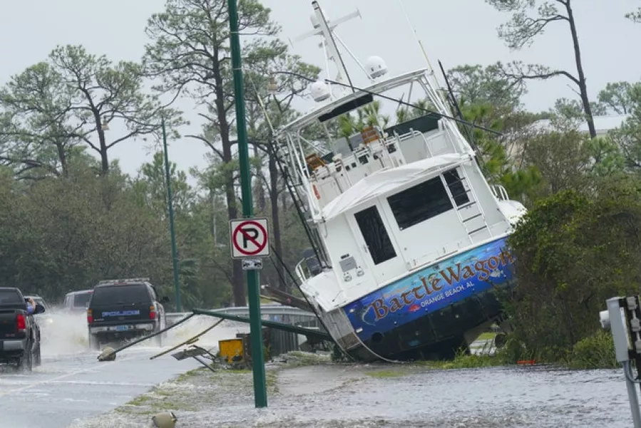 A boat is washed up near a road after Hurricane Sally moved through Orange Beach, Alabama (Gerald Herbert/AP)