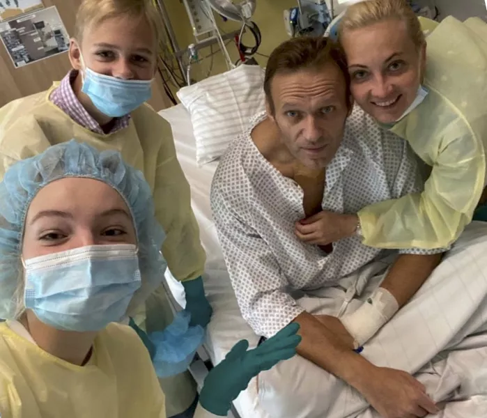 Alexei Navalny with his wife Yulia (right) daughter Daria and son Zakhar at his hospital bed (AP)