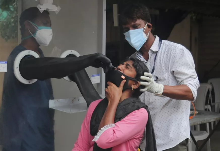 Health workers collect a nasal swab sample to test for Covid-19 in Hyderabad, India (AP)