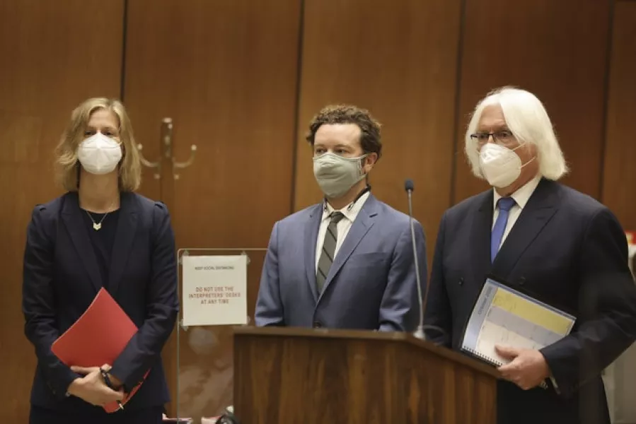 Actor Danny Masterson, centre, stands with his attorneys (Lucy Nicholson/Pool Photo via AP)