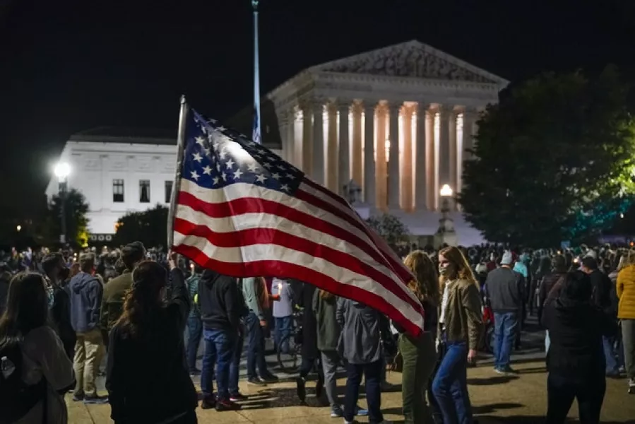 People gather at the Supreme Court in Washington on Saturday (J. Scott Applewhite/AP)