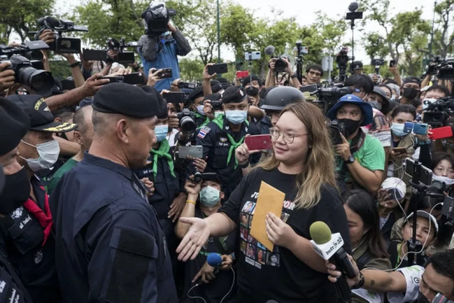 A pro-democracy student leader negotiates with police officials as they march during a protest in Bangkok on Sunday (Wason Wanichakorn)