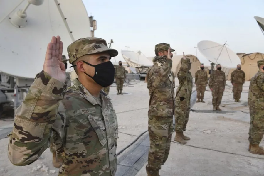 Airmen deployed to Al-Udeid Air Base, Qatar, during an enlistment ceremony as they transferred into the Space Force (Staff Sgt Kayla White/US Air Force via AP)