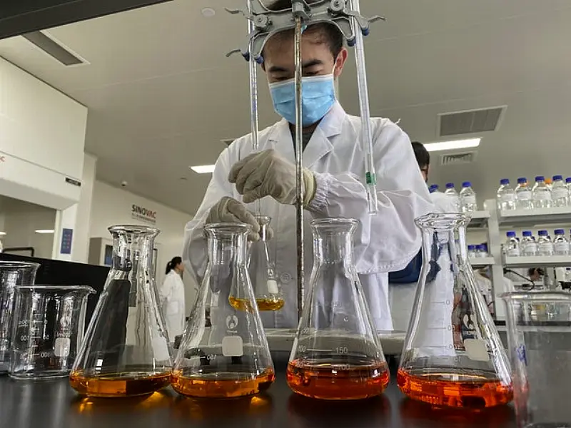 A worker inside a lab at the SinoVac vaccine factory south of Beijing (Ng Han Guan/AP)