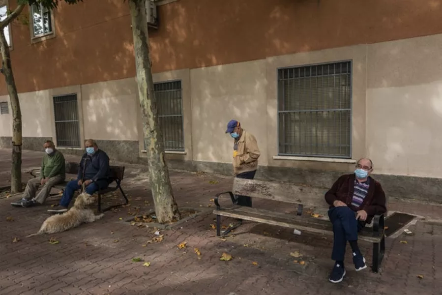 Elderly men wearing face masks to prevent the spread of the coronavirus in Vallecas, Madrid (Bernat Armangue/AP)