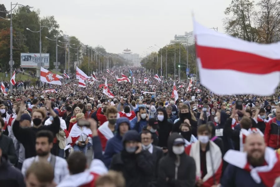 People with old Belarusian national flags march during an opposition rally (AP/TUT.by)