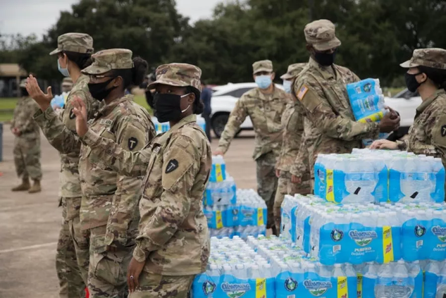 National Guard soldiers distribute bottled water to residents after contamination of the water supply (Marie D. De Jesús/Houston Chronicle /AP)