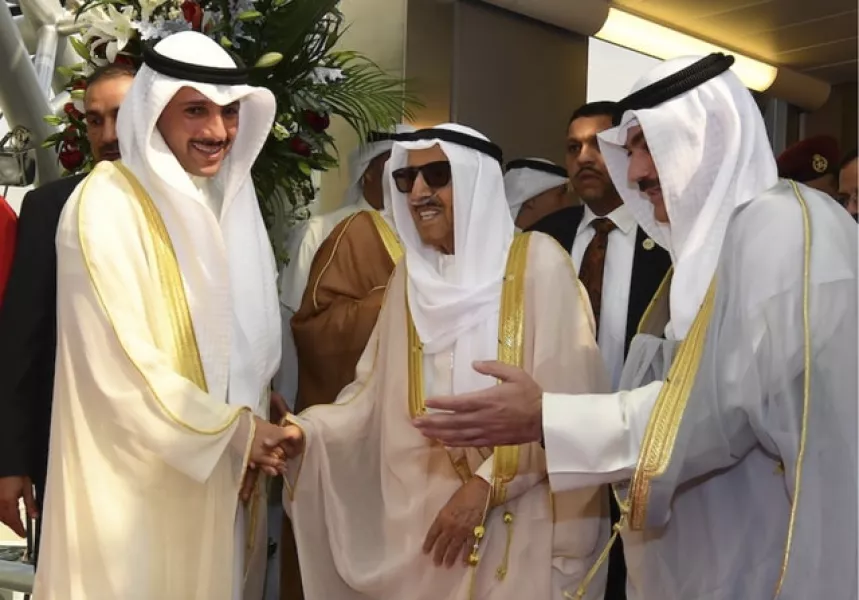 Sheikh Sabah al-Ahmad al-Sabah, middle, arrives home from the US (Kuna/AP)