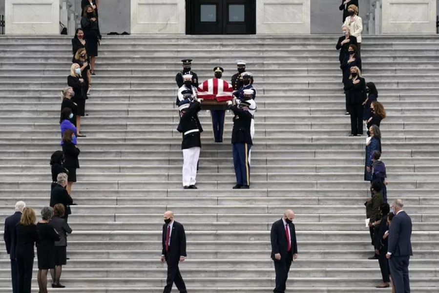 The casket of Justice Ruth Bader Ginsburg is carried out by a military honour guard after lying in state at the US Capitol (J Scott Applewhite/AP)