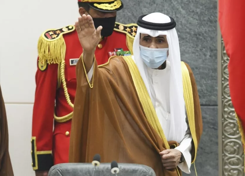 The new Emir of Kuwait Sheikh Nawaf Al Ahmad Al Sabah waves after he performed the constitutional oath (AP/Jaber Abdulkhaleg)