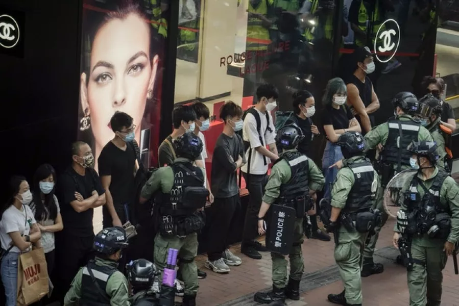Police check pedestrians during China’s National Day in Causeway Bay, Hong Kong (AP/Kin Cheung)