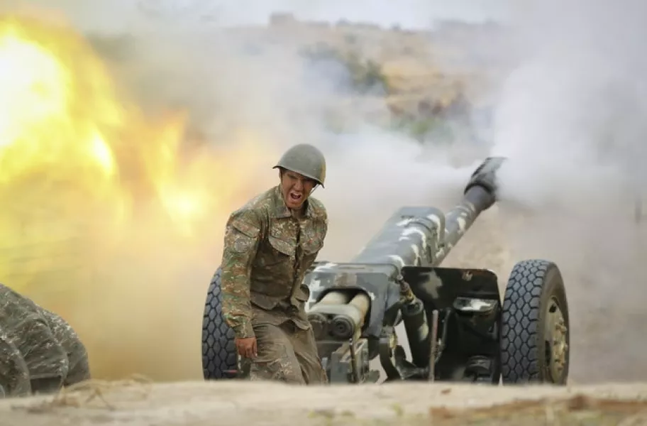 An Armenian serviceman fires a cannon towards Azerbaijan positions in Nagorno-Karabakh (Sipan Gyulumyan/Armenian Defense Ministry Press Service/PAN Photo via AP)