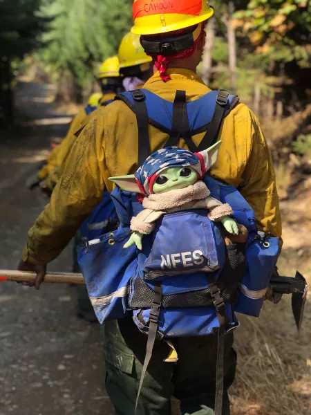 Baby Yoda hitches a ride in the backpack of an Oregon Air National Guard firefighter (Courtesy of Jaebyn Drake via AP)