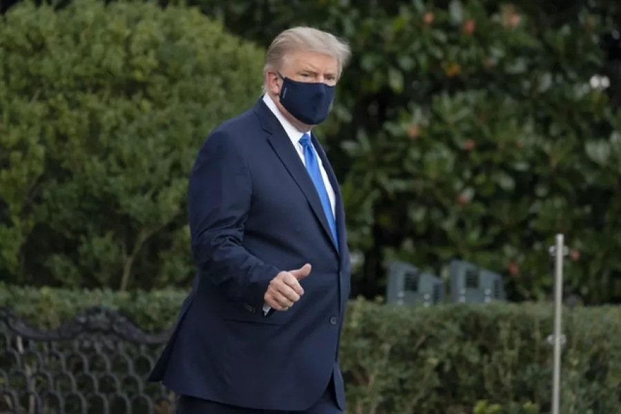 President Donald Trump gives a thumbs up as he leaves the White House to go to Walter Reed National Military Medical Centre (Alex Brandon/AP)