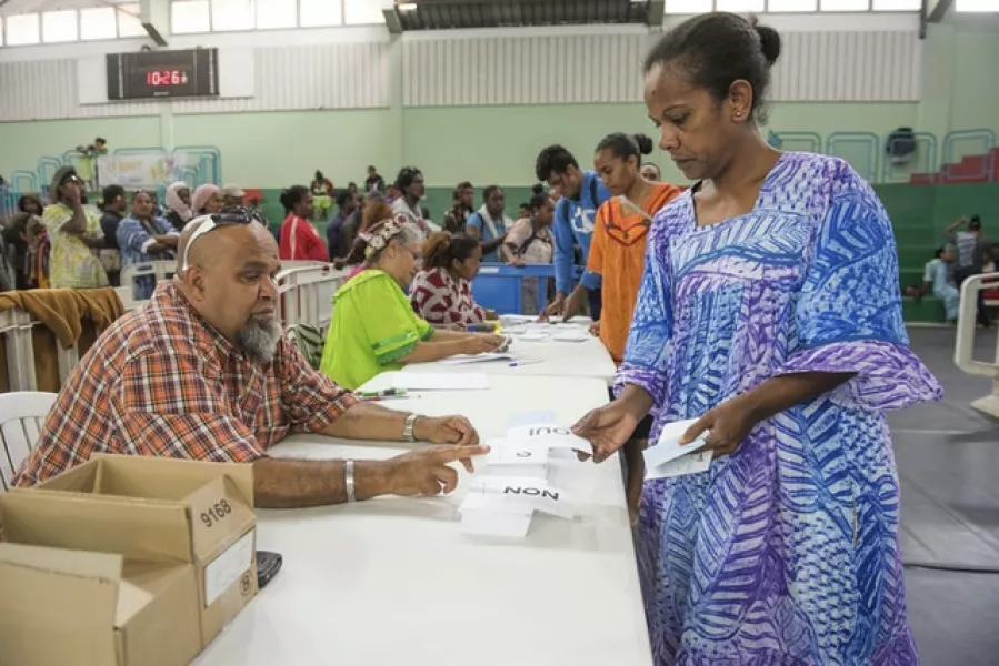 A woman votes in the independence referendum in New Caledonia (Mathurin Derel/AP)