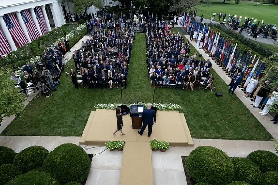 Judge Amy Coney Barrett walks to the microphone after being announced by President Donald Trump (right) as his nominee for the Supreme Court, in the Rose Garden at the White House on Saturday September 26 (Alex Brandon/AP)