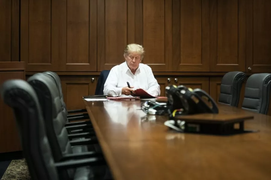 Donald Trump works in the conference room of his suite at Walter Reed National Military Medical Centre in Bethesda, Maryland (Joyce N Boghosian/The White House/AP)