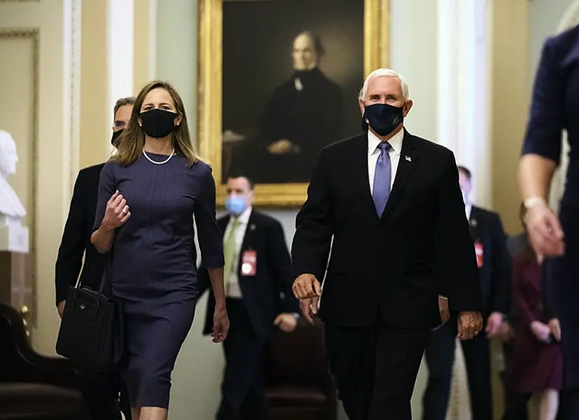 Judge Amy Coney Barrett, left, President Donald Trump’s nominee for the US Supreme Court, is escorted to the Senate by Vice President Mike Pence (J. Scott Applewhite/AP)