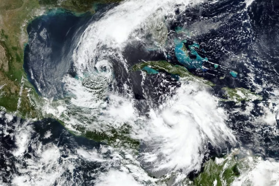 Tropical Storm Gamma, left, and a strengthening Hurricane Delta, lower right (Nasa/AP)