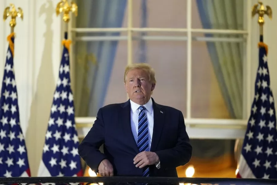 President Donald Trump on the balcony outside of the Blue Room as returned to the White House on Monday (Alex Brandon/AP)