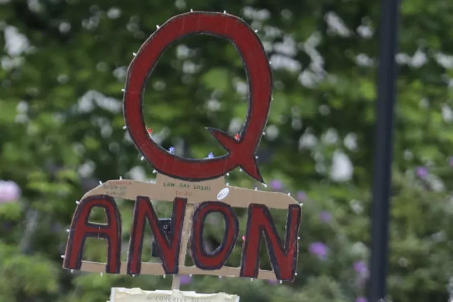 Facebook will remove pages, groups and Instagram accounts for “representing QAnon.” (Ted Warren/AP)