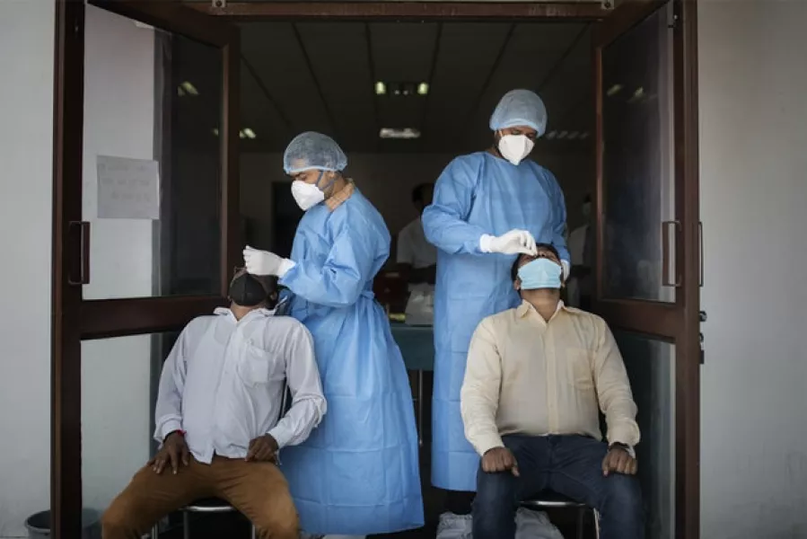 Covid antigen testing at an agricultural institute in New Delhi (Altaf Qadri/AP)