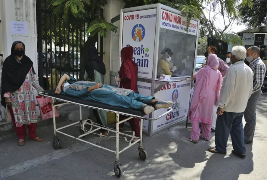 People wait to test for Covid-19 at a government hospital in Jammu, India (Channi Anand/AP)