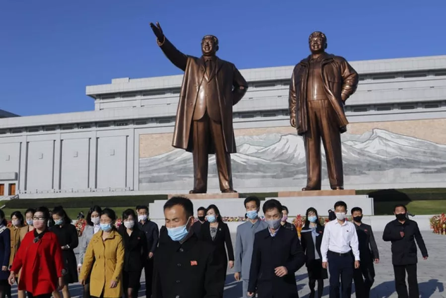 People visit the Mansu Hill to lay flowers to the bronze statues of former North Korean leaders Kim Il Sung and Kim Jong Il (Cha Song Ho/AP)